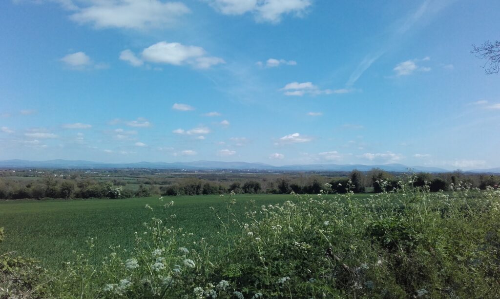 Peaceful countryside landscape with open sky symbolising calm, clarity, and emotional relief from anxiety through hypnotherapy